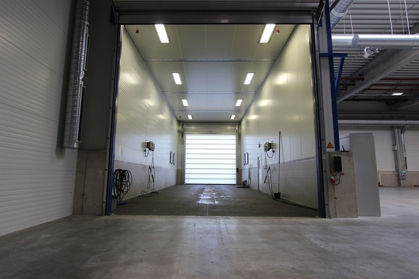 Two-door cleaning booth for utility vehicles